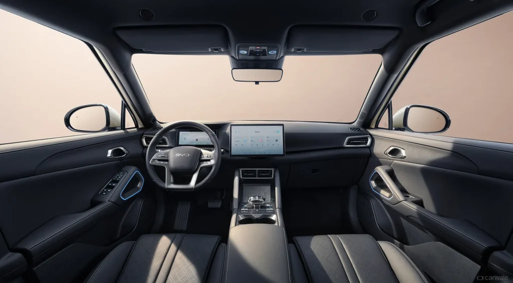 byd atto 3 interior being showed with infotainment and steering wheel and controls.