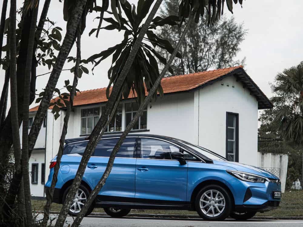 Sky blue coloured BYD E6 parked in front of a house