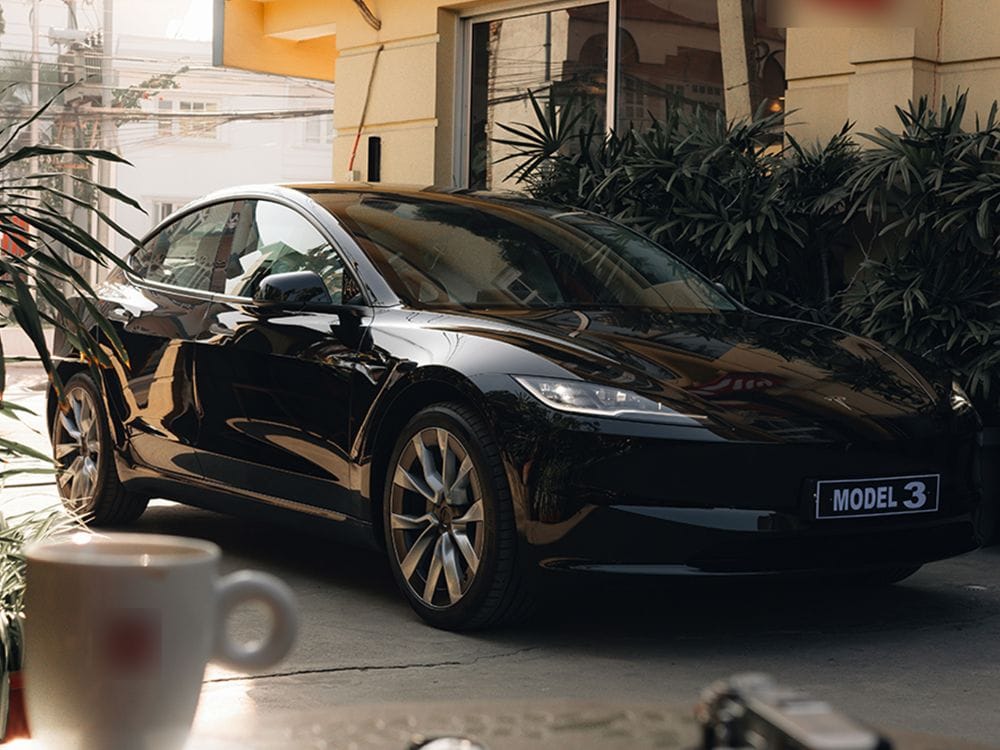 black coloured tesla model 3 parking